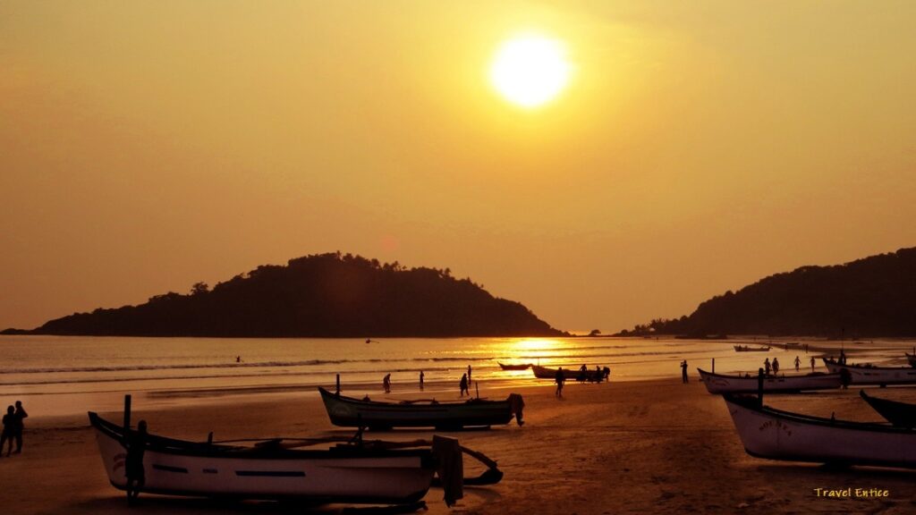 boats on a beach with a sunset